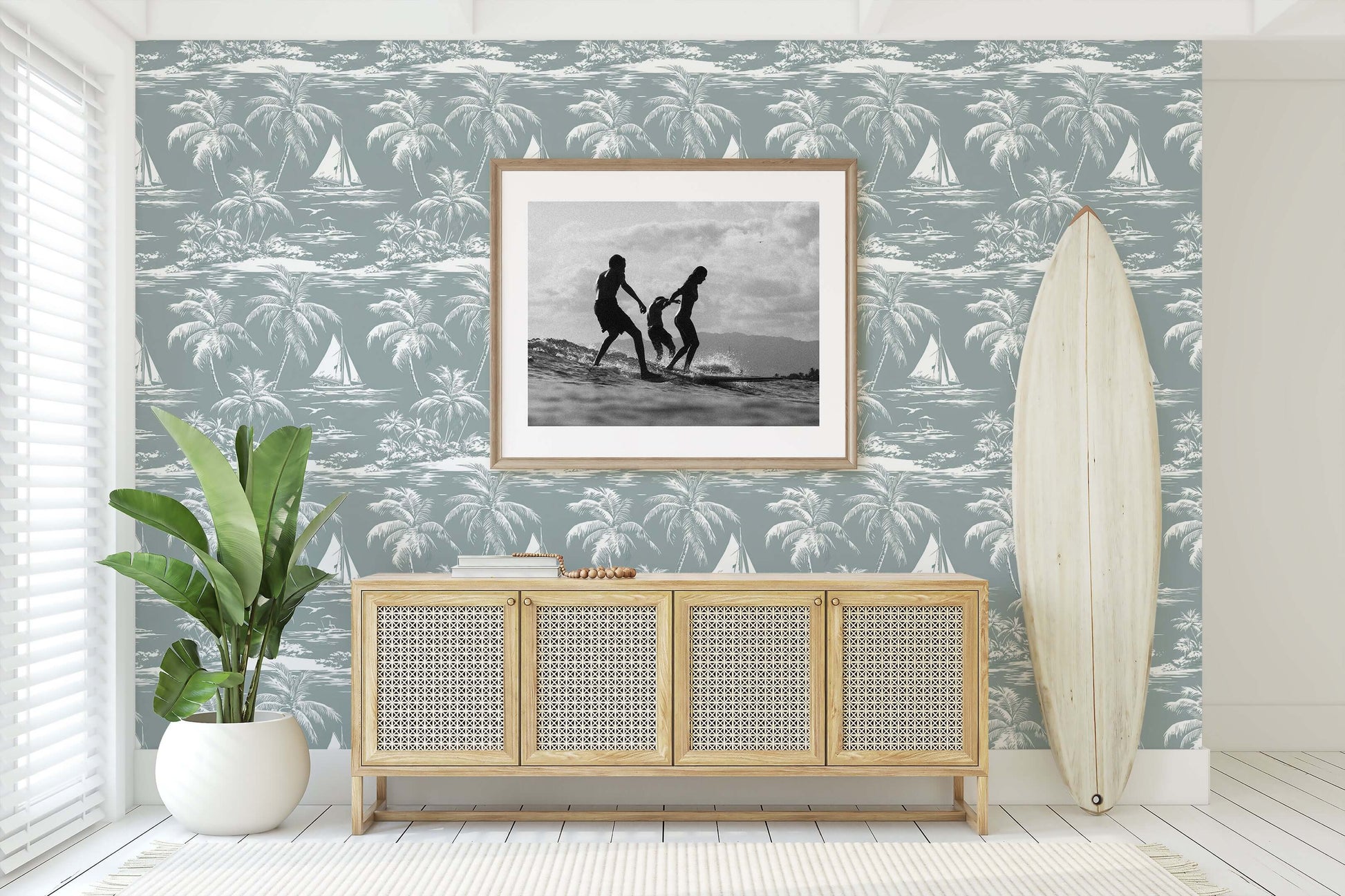 Lagoon Tranquility wallpaper with palm trees and boats in a coastal living room setting, featuring a surfboard and framed art.