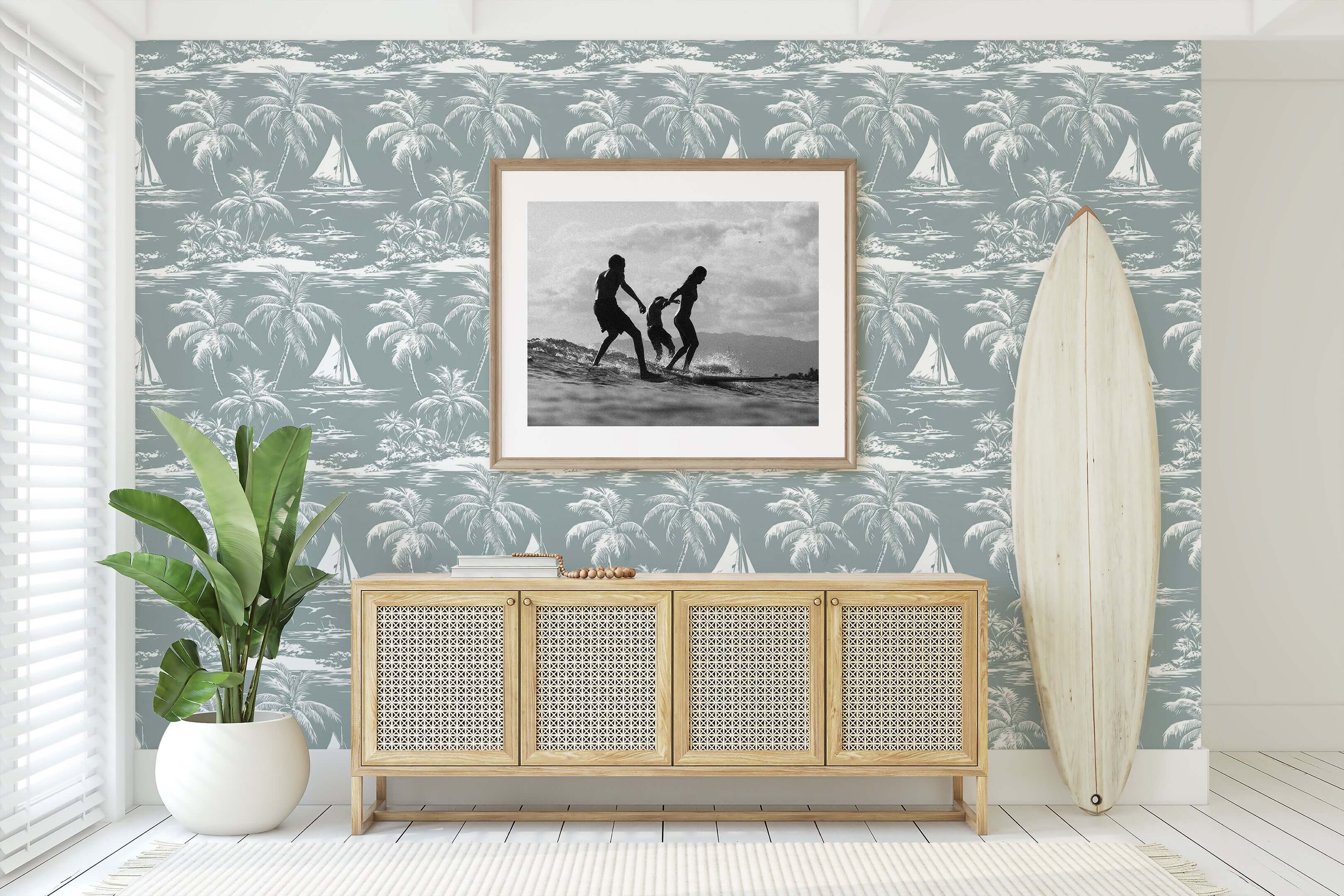 Lagoon Tranquility wallpaper with palm trees and boats in a coastal living room setting, featuring a surfboard and framed art.