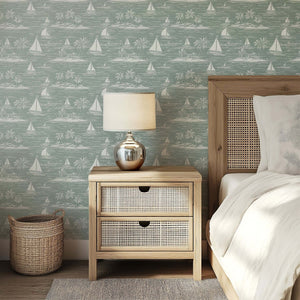 Harbor Calm wallpaper featuring boats and palm trees in a coastal toile design in a serene bedroom setting.