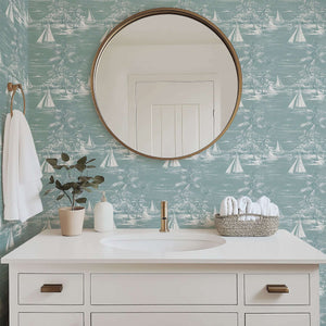 Bathroom with 'Lagoon Views' coastal wallpaper featuring sailboats and palm trees, enhancing a serene seaside aesthetic with ocean charm.