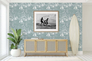 Coastal room with Lagoon Views wallpaper depicting sailboats and palm trees, enhancing the serene seaside aesthetic with boating elements.