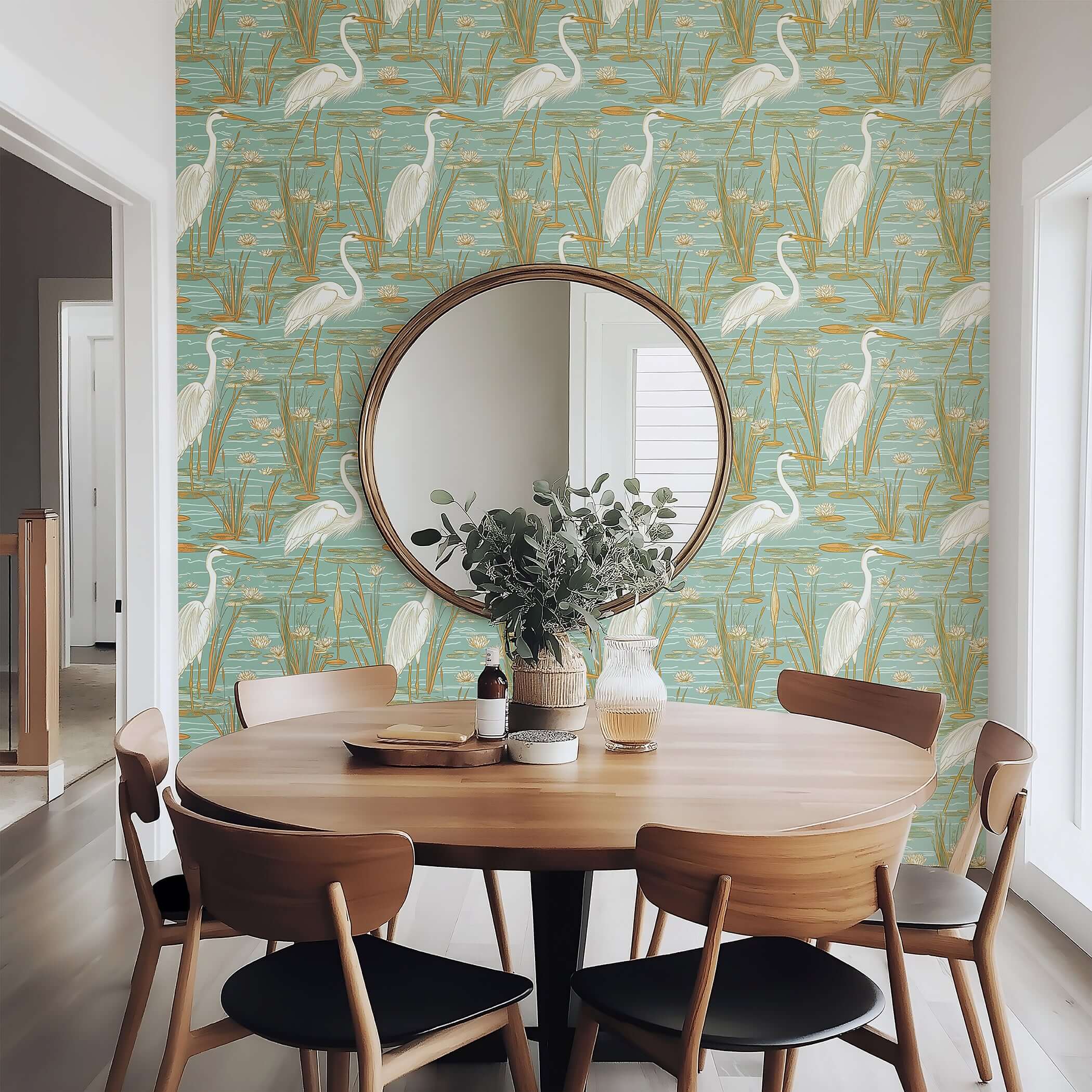 Coastal dining room with 'Tranquil Marshland' wallpaper featuring blue herons, teal, and tan tones for a serene atmosphere.
