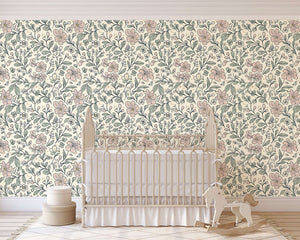 Nursery with 'Little Blossoms Garden' wallpaper featuring pink floral and leafy designs, perfect for a cottagecore baby room or playroom.