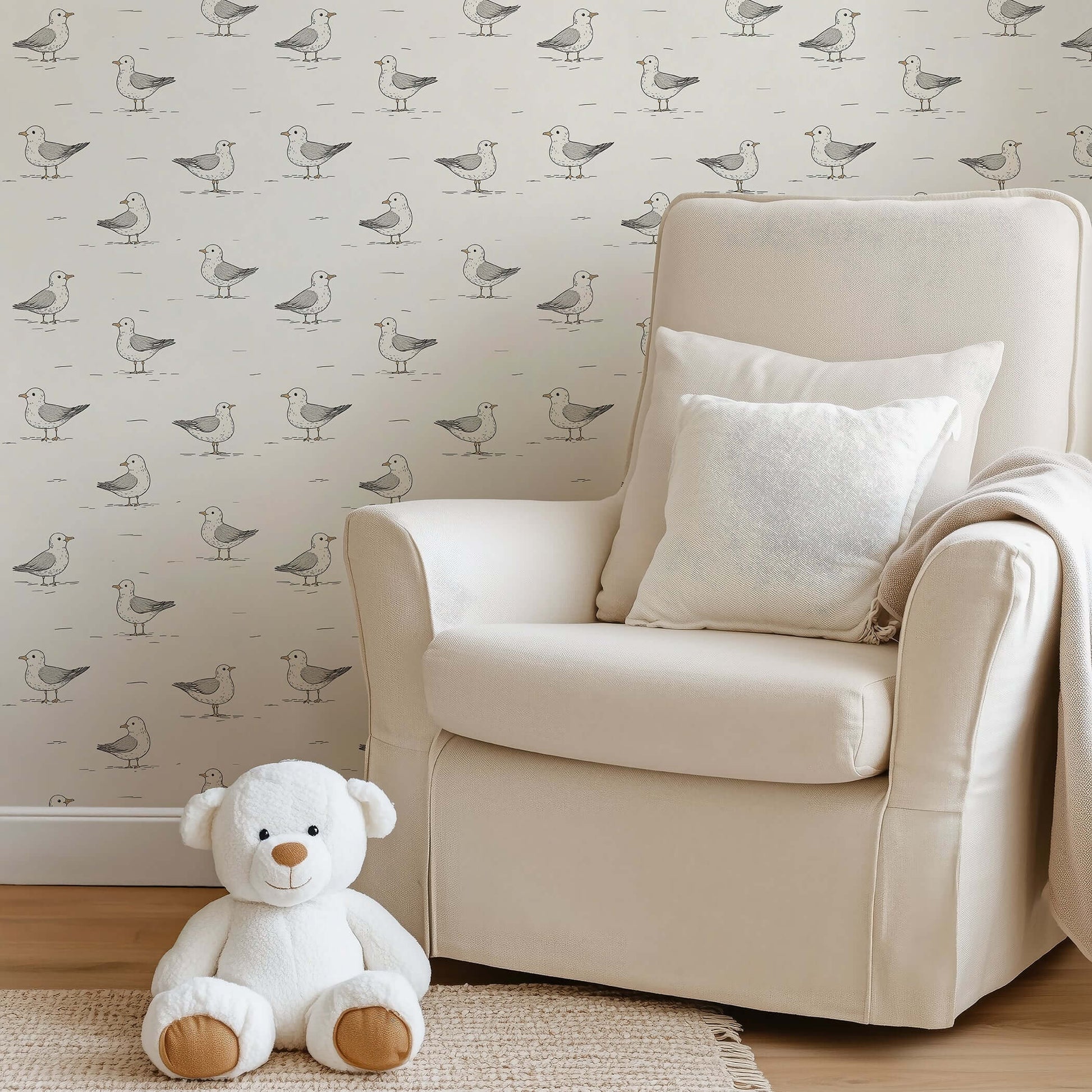 Playful seagull wallpaper in a cozy nursery with a cream armchair and teddy bear, perfect for children's rooms and modern design.
