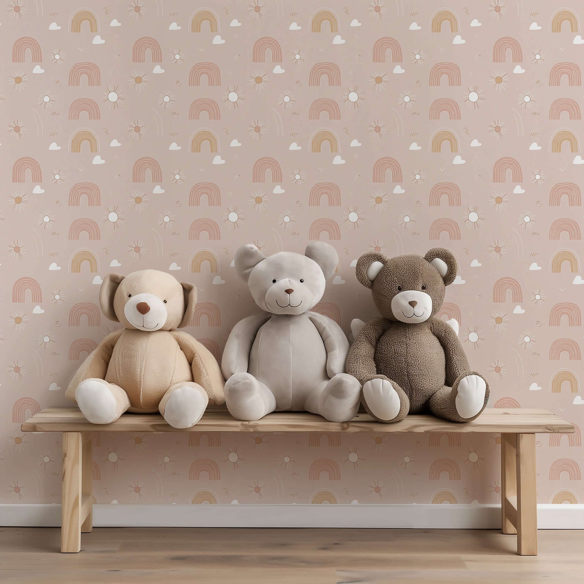Three plush bears sit on a bench against pink Dreamy Rainbows wallpaper, perfect for modern nurseries and playrooms.