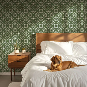 Bedroom with green and white floral wallpaper, modern design with dog on white bed, featuring geometric elegance and timeless charm.