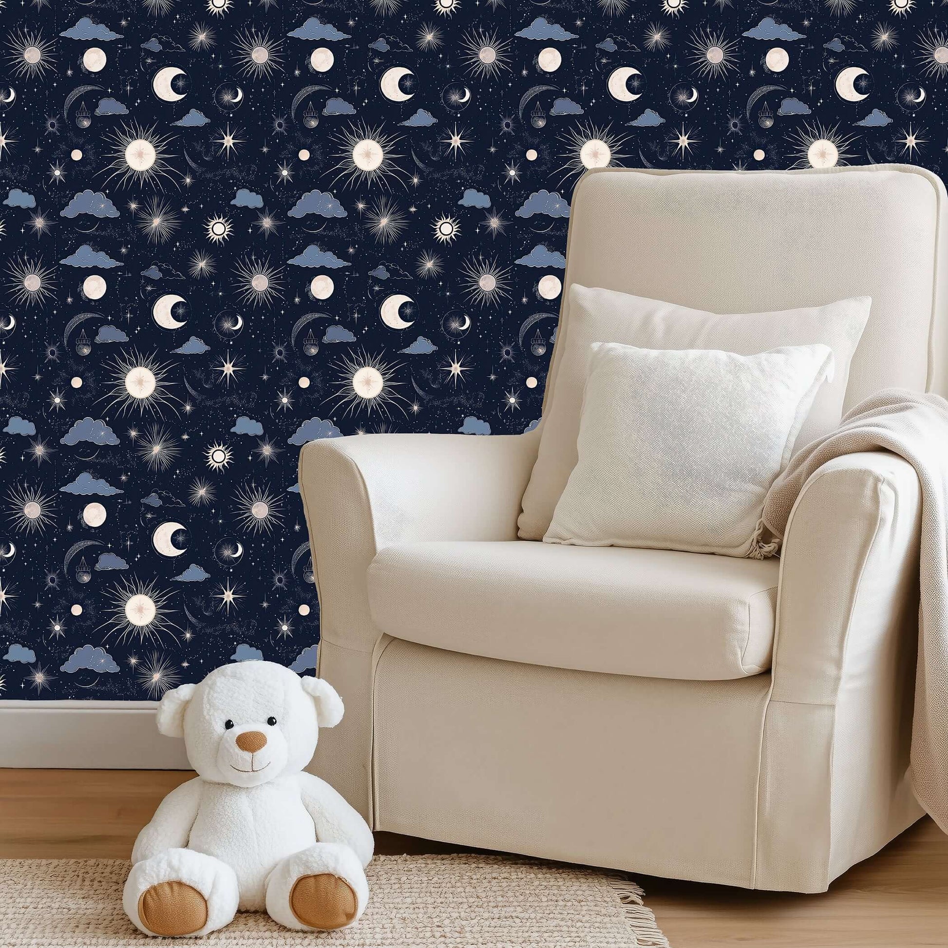 Cozy nursery with 'Night and Lullaby' wallpaper featuring navy skies, crescent moons, stars, clouds, and a plush teddy bear.