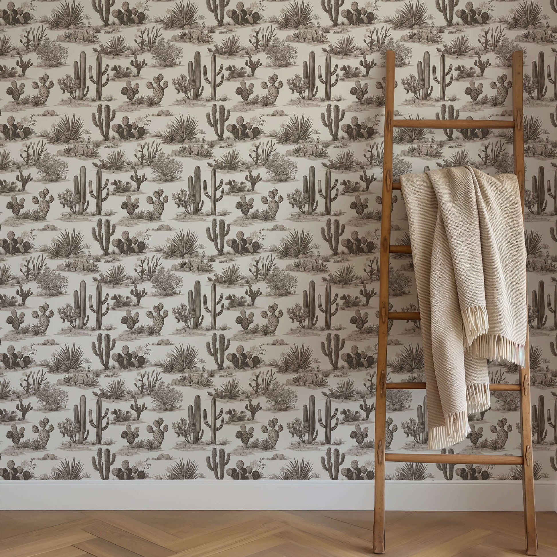 Desert Toile Elegance Wallpaper featuring cactus and succulents with a ladder draped in a beige throw, ideal for sophisticated spaces.