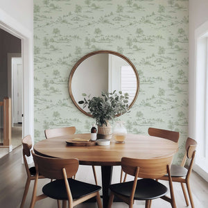 Dining room with Lush Pastoral Toile wallpaper showcasing French toile landscape in soft green hues, enhancing vintage charm.