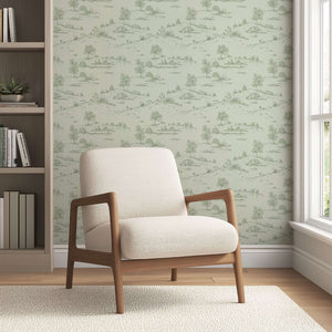 Elegant room with Lush Pastoral Toile wallpaper featuring soft green tones and French toile landscape design behind a modern chair.