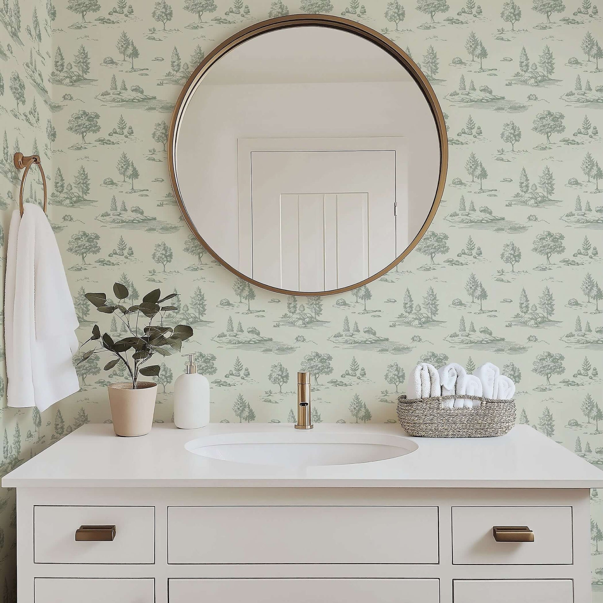 Bathroom with mirror reflecting serene green toile landscape wallpaper featuring woodlands and streams by Wall Artifacts.