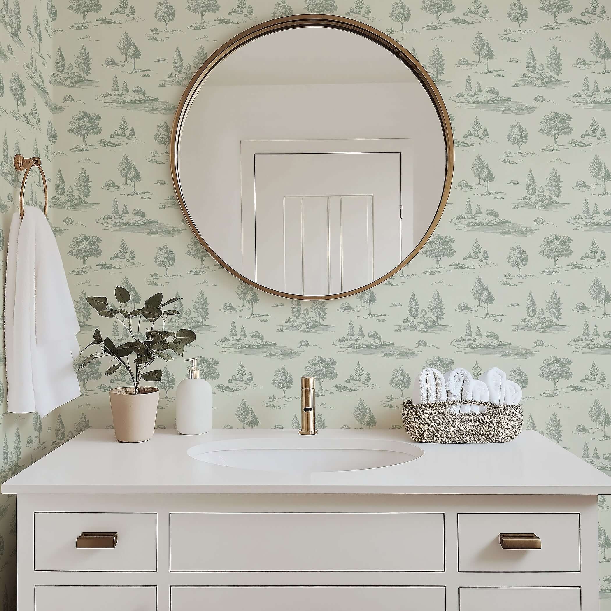 Bathroom with mirror reflecting serene green toile landscape wallpaper featuring woodlands and streams by Wall Artifacts.
