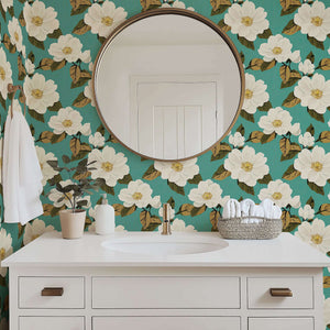 Magnolia Bliss wallpaper featuring creamy white magnolias on teal background with green and golden-brown leaves, perfect for vintage design.