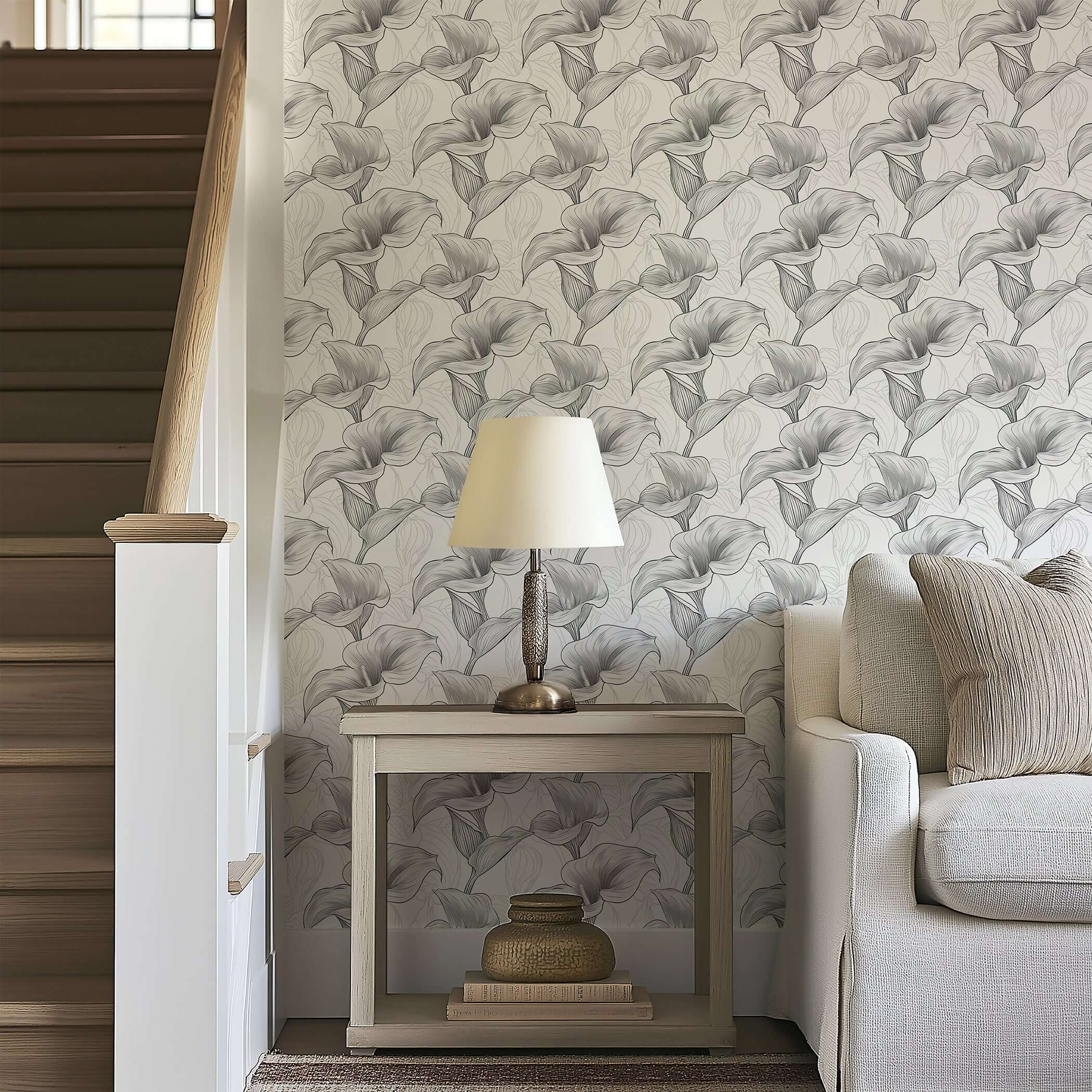 Monochrome Lily Grace wallpaper with calla lilies on a grayscale background, enhancing modern design in a cozy living room setting.
