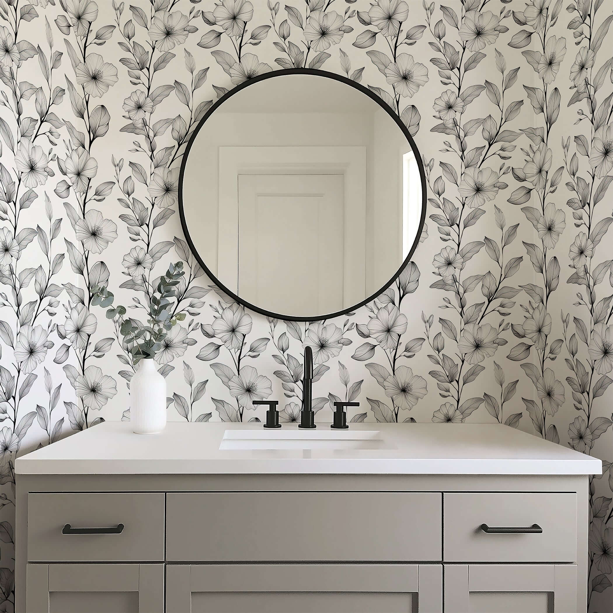 Bathroom featuring Black and White Bloomscape floral wallpaper with monochrome flowers, a round mirror, and modern decor.