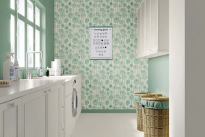 Laundry room with Green Garden Romance wallpaper, featuring green botanical and floral patterns on a cream background.