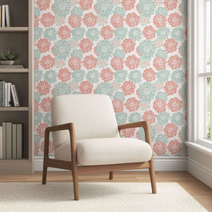 Pink and teal dahlia flowers on white wallpaper behind beige armchair; perfect for adding charm with its abstract floral design.