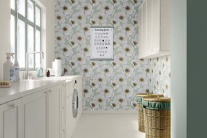 Laundry room with modern floral wallpaper featuring white blossoms on soft green, accentuating a contemporary botanical style.
