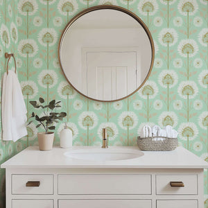 Modern mint green wallpaper with white floral starburst design in a bathroom setting, featuring a round mirror and contemporary sink.