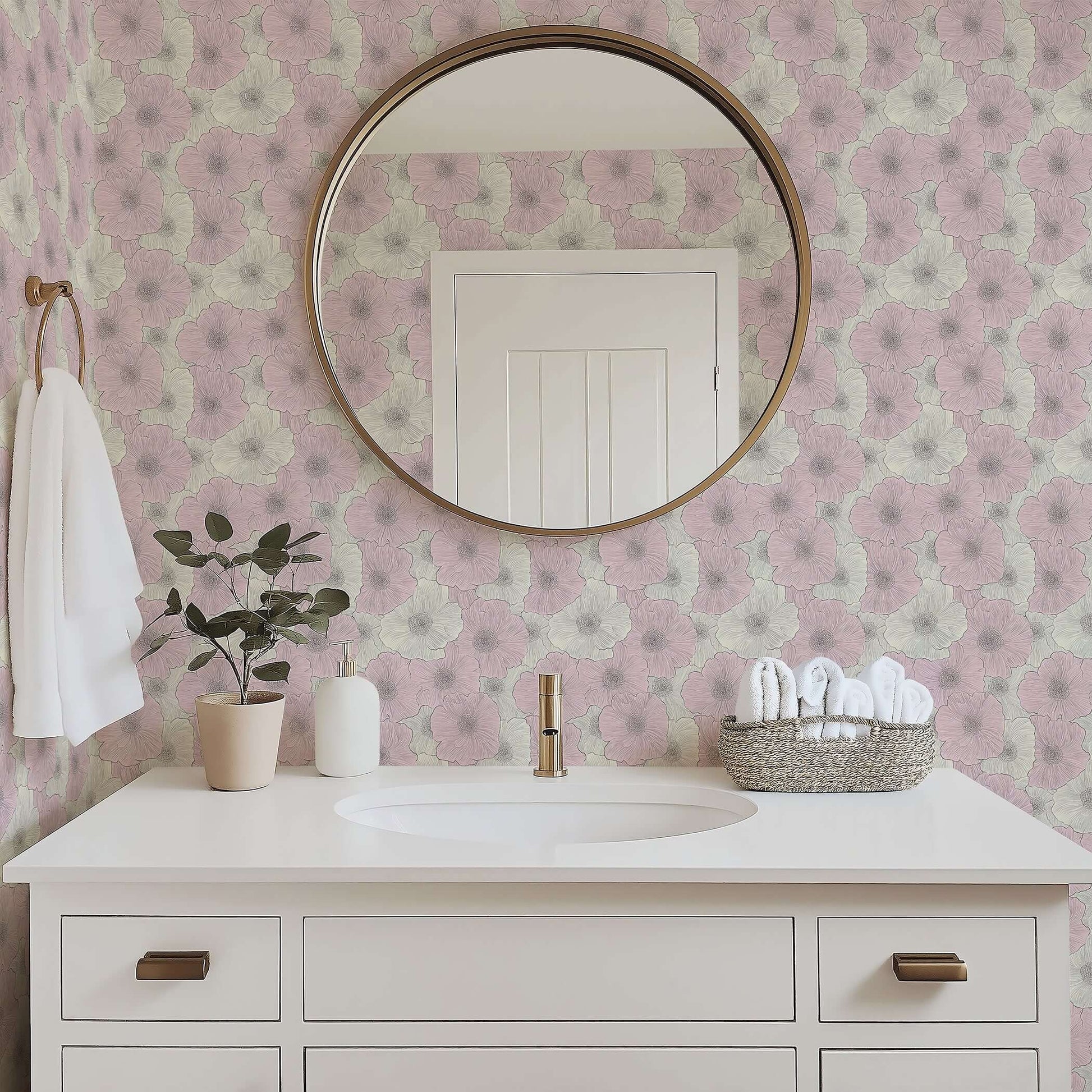 Contemporary bathroom with pink floral wallpaper, round mirror, white vanity, and potted plant, showcasing elegant modern decor.