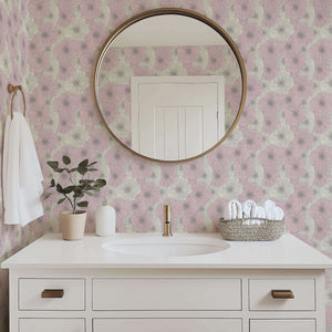Contemporary bathroom with pink floral wallpaper, round mirror, white vanity, and potted plant, showcasing elegant modern decor.