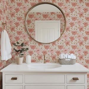 Elegant bathroom with Blush Peony Dream floral wallpaper in pink and peach hues, featuring a round mirror and minimalist decor.