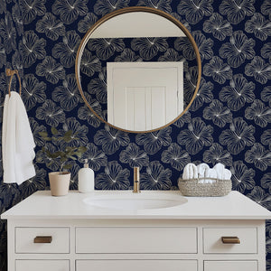 Island Nights Floral Wallpaper with white hibiscus on navy, enhancing a bathroom decor with tropical elegance and modern coastal flair.