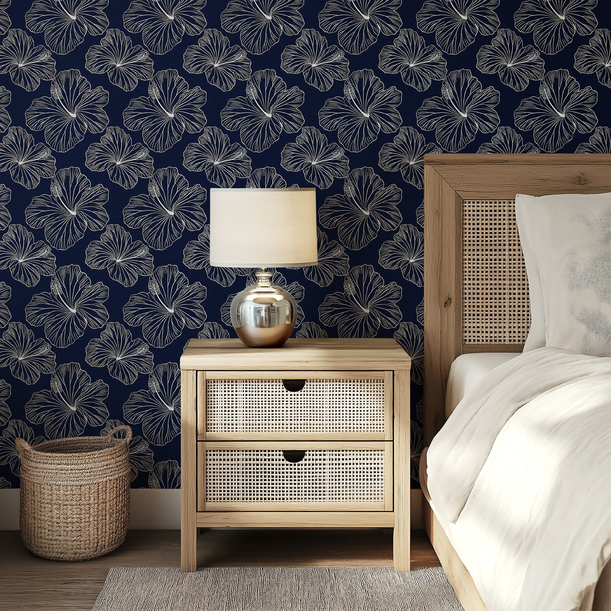 Island Nights Floral Wallpaper with white hibiscus flowers on navy background adds tropical flair to bedroom decor.
