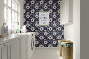 Floral navy boho wallpaper with pink and cream flowers adds whimsical cottagecore charm to a modern laundry room wall.