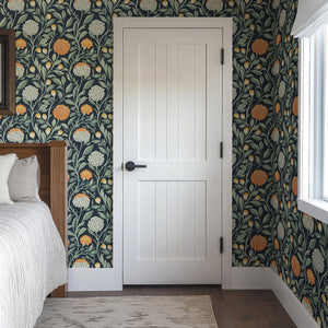 Luxurious "Twilight Chrysanthemum" wallpaper with orange and ivory flowers on a navy background, adding sophistication and warmth to a bedroom.