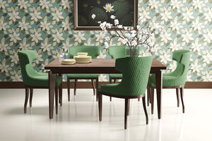 Dining room with green chairs and table against classic bloom bliss wallpaper featuring ivory floral design on teal background.