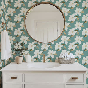Retro floral wallpaper with ivory blooms on teal background, complemented by a white vanity and mirror, creating a modern, timeless look.