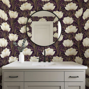 Modern bathroom with Golden Veil Floral art deco wallpaper; ivory and gold flowers on purple background, above gray vanity with round mirror.