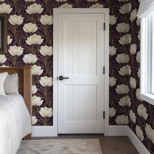 Golden Veil Floral Wallpaper with ivory blooms and gold accents on a plum background, adding modern art deco elegance to the bedroom.