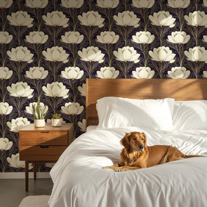 Art deco floral wallpaper with creamy white flowers on dark plum, accented by gold, in a modern bedroom with a dog on the bed.