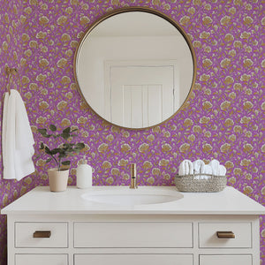 Bathroom with lilac floral wallpaper featuring golden and ivory vintage blooms, mirror, white sink, and decorative accents.