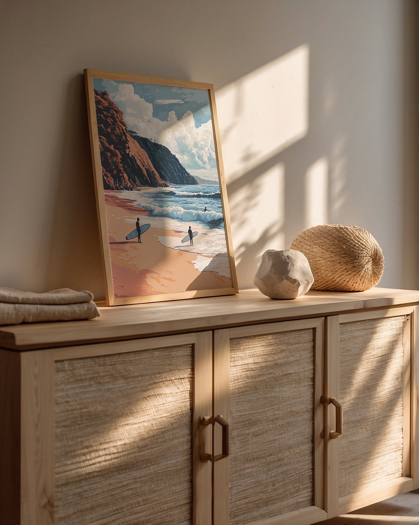 Framed Malibu Surf wall art featuring surfers at the beach with sunlit cliffs and ocean in a modern home setting.