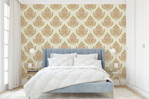 Royal Rose Crest wallpaper in a bedroom with floral damask pattern, featuring pink and gold tones on a tan background, creating vintage elegance.