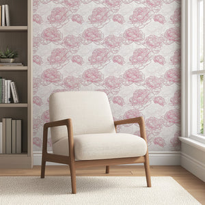 Modern monochrome wallpaper with red and white peony flowers behind a beige armchair in a cozy living room setting.