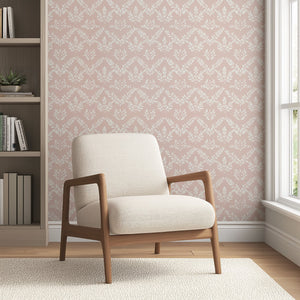 Modern room with chair and floral "Blushing Botanicals" wallpaper featuring ivory botanical silhouettes and laurel patterns on blush background.