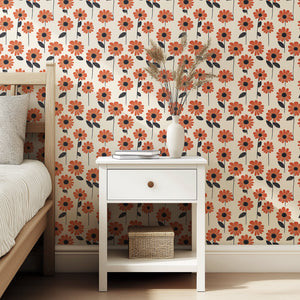 Retro-inspired wallpaper with orange daisies and bold black centers on a cream backdrop, perfect for modern floral-themed spaces.