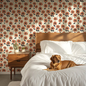 Retro orange daisy floral wallpaper with a cheerful dog on a bed, perfect for modern and eclectic spaces seeking vibrant decor.