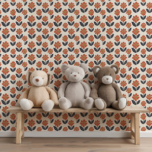 Teddy bears on a bench against retro flower power wallpaper with orange blossoms, navy foliage, and yellow centers. Vintage floral design.