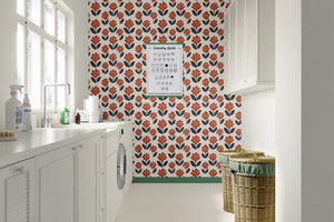 Retro Flower Power wallpaper with orange blossoms and navy foliage in a modern kitchen setting, adding a burst of floral charm.