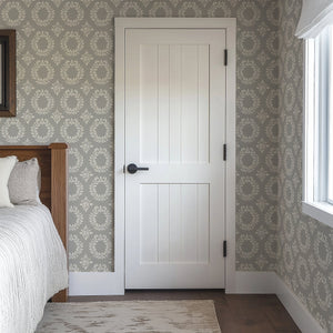 Timeless Floral Wreaths Wallpaper featuring ivory laurel designs on a sage-gray background in a sophisticated bedroom setting.