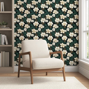 Elegant Jungle Escape wallpaper with cream flowers and green palm fronds on a dark backdrop, featuring a modern chair; floral, jungle design.