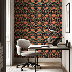 Colorful floral wallpaper with vibrant coral, red, and green flowers on a dramatic dark background in a stylish interior setting.