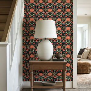 Vibrant floral wallpaper with coral and green flowers on a dark background, adding character to a hallway interior.