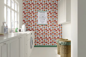 Retro floral wallpaper with red and orange flowers on a cream background in a modern laundry room. Keywords: flowers, children, retro.