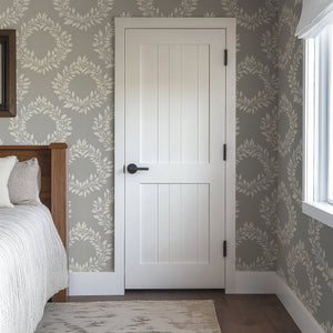Elegant Leaf Wreaths wallpaper in muted gray with white laurel wreaths, adding traditional sophistication to a bedroom.